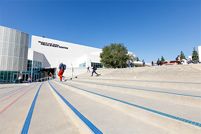 main entrance at apu's west campus with students going down the stairs