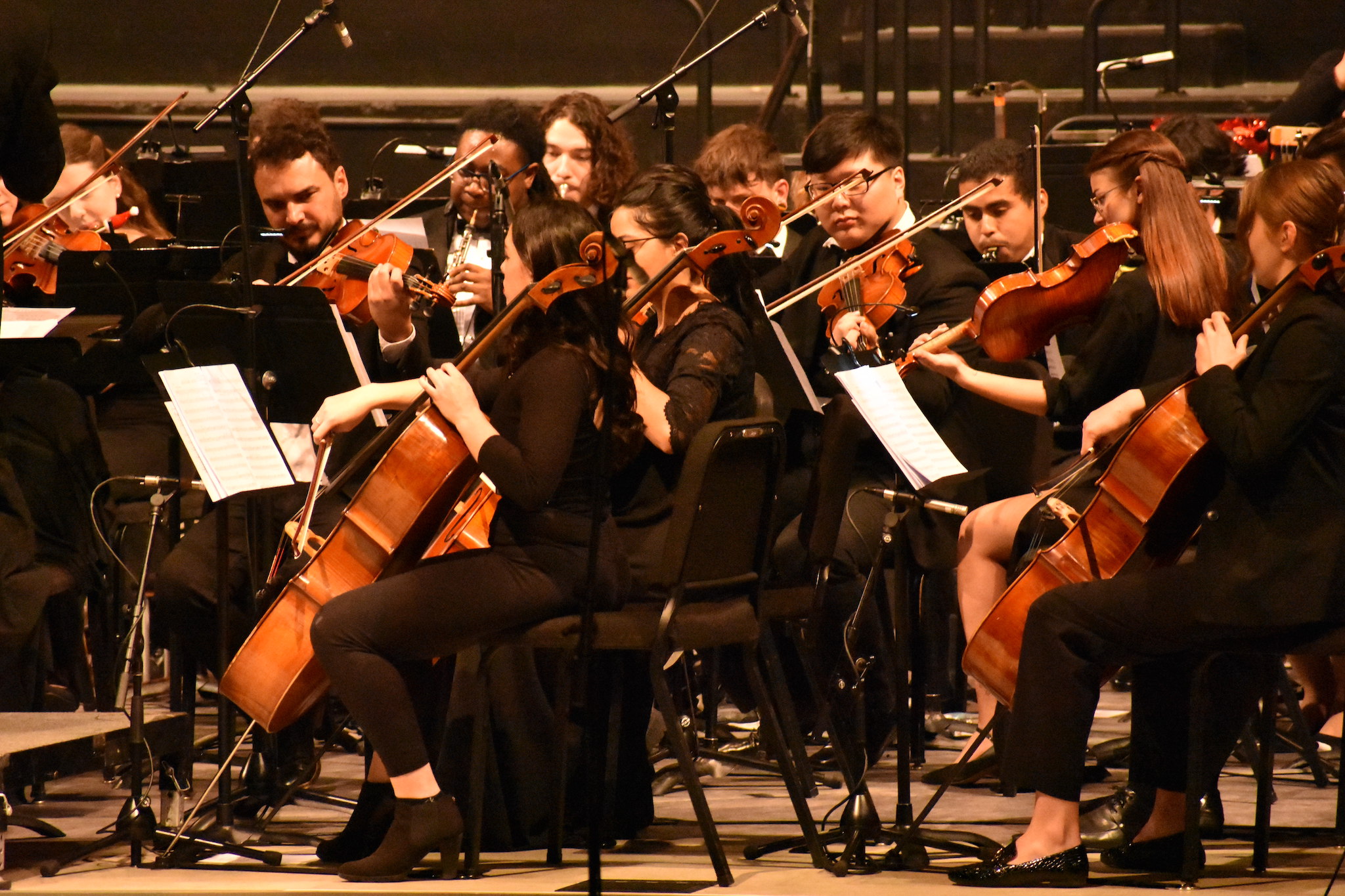 students playing their instruments during orchestra