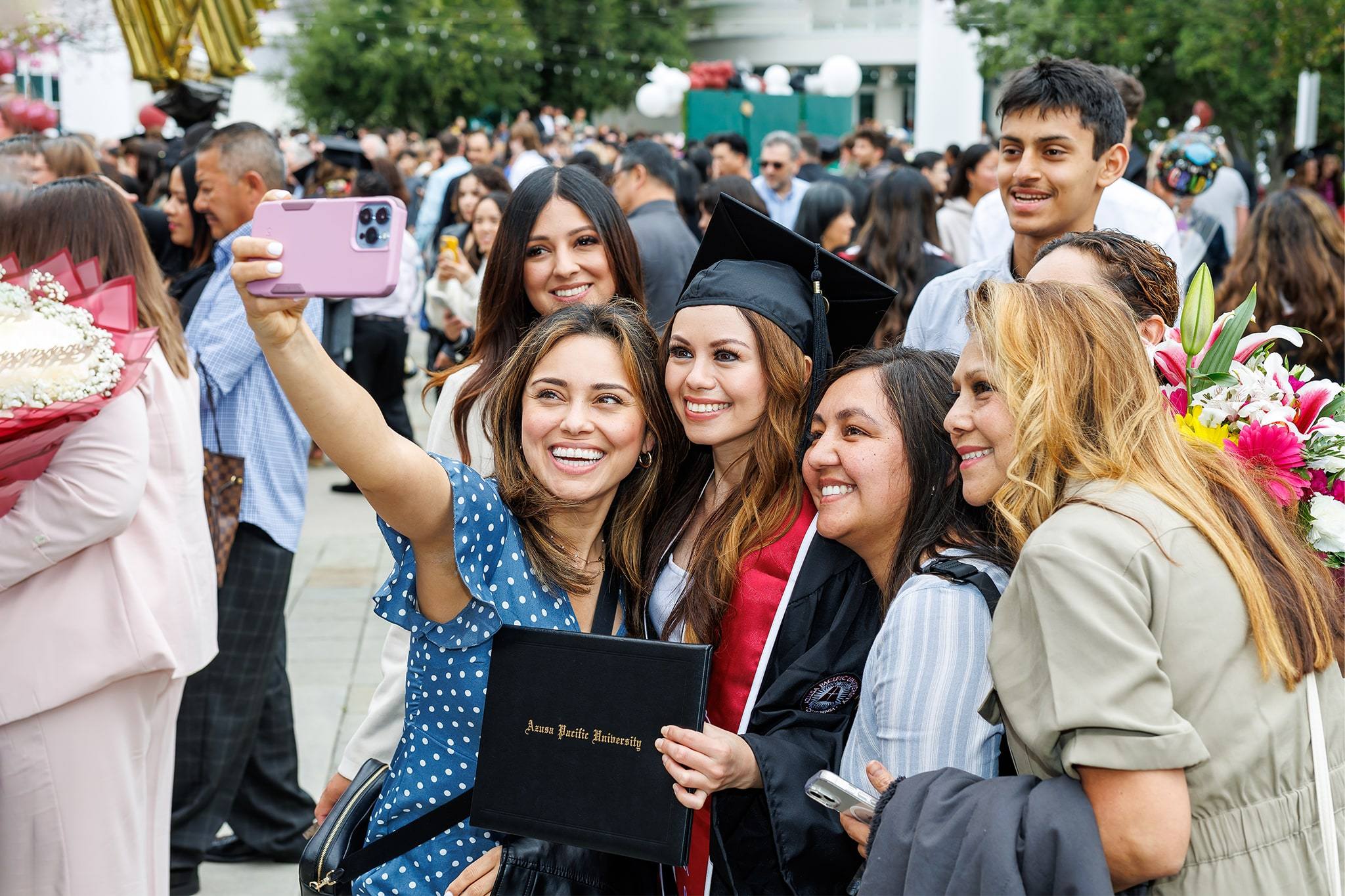 A group of hispanic females taking a selfie at graduation