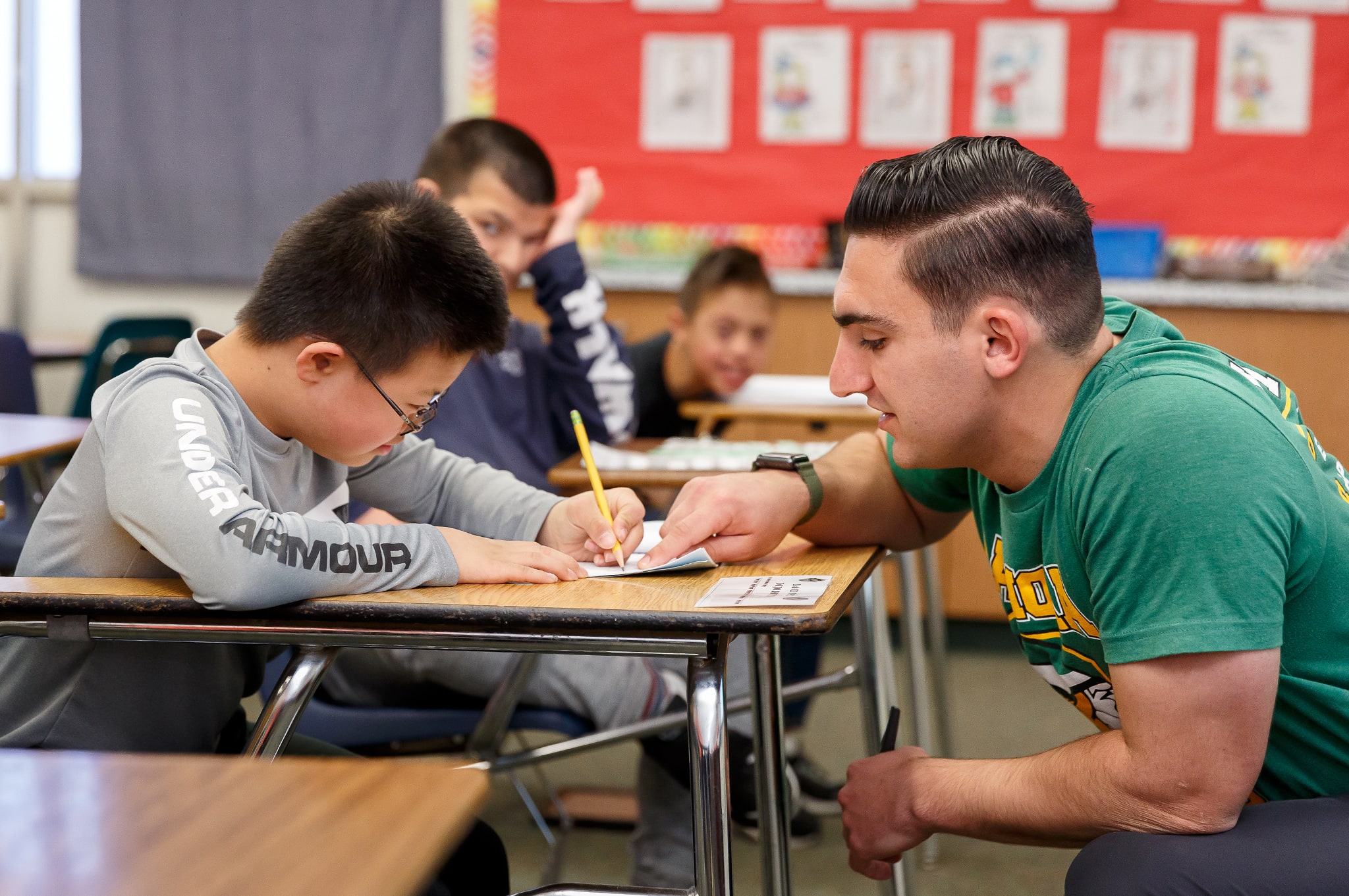 professor guiding a student during class activity