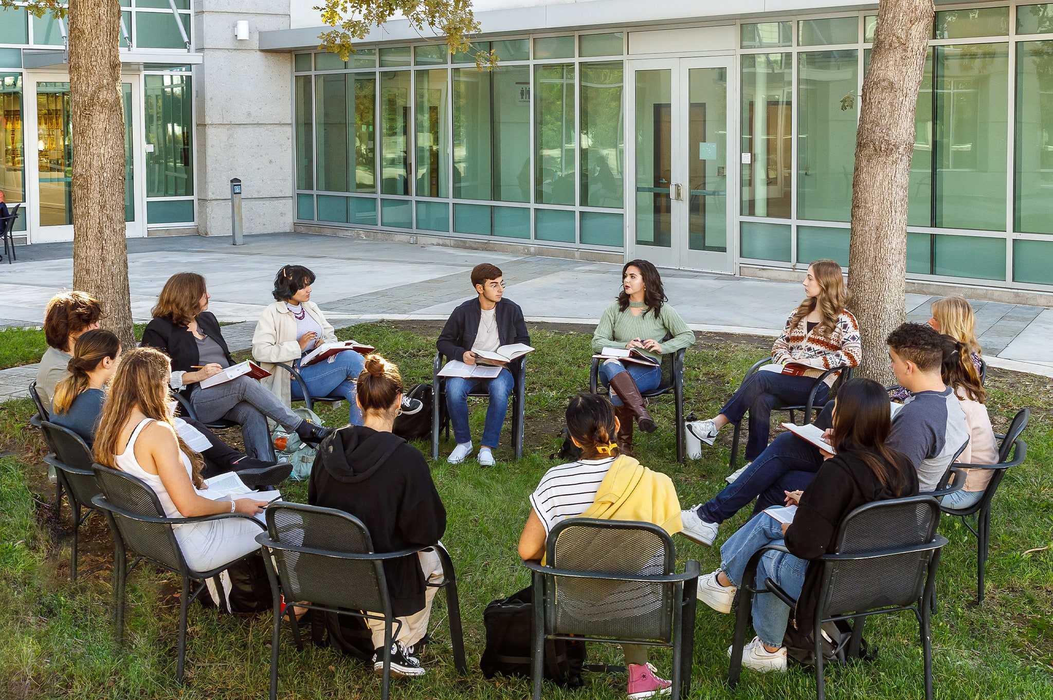 students and professor outside of darling library during a class activity