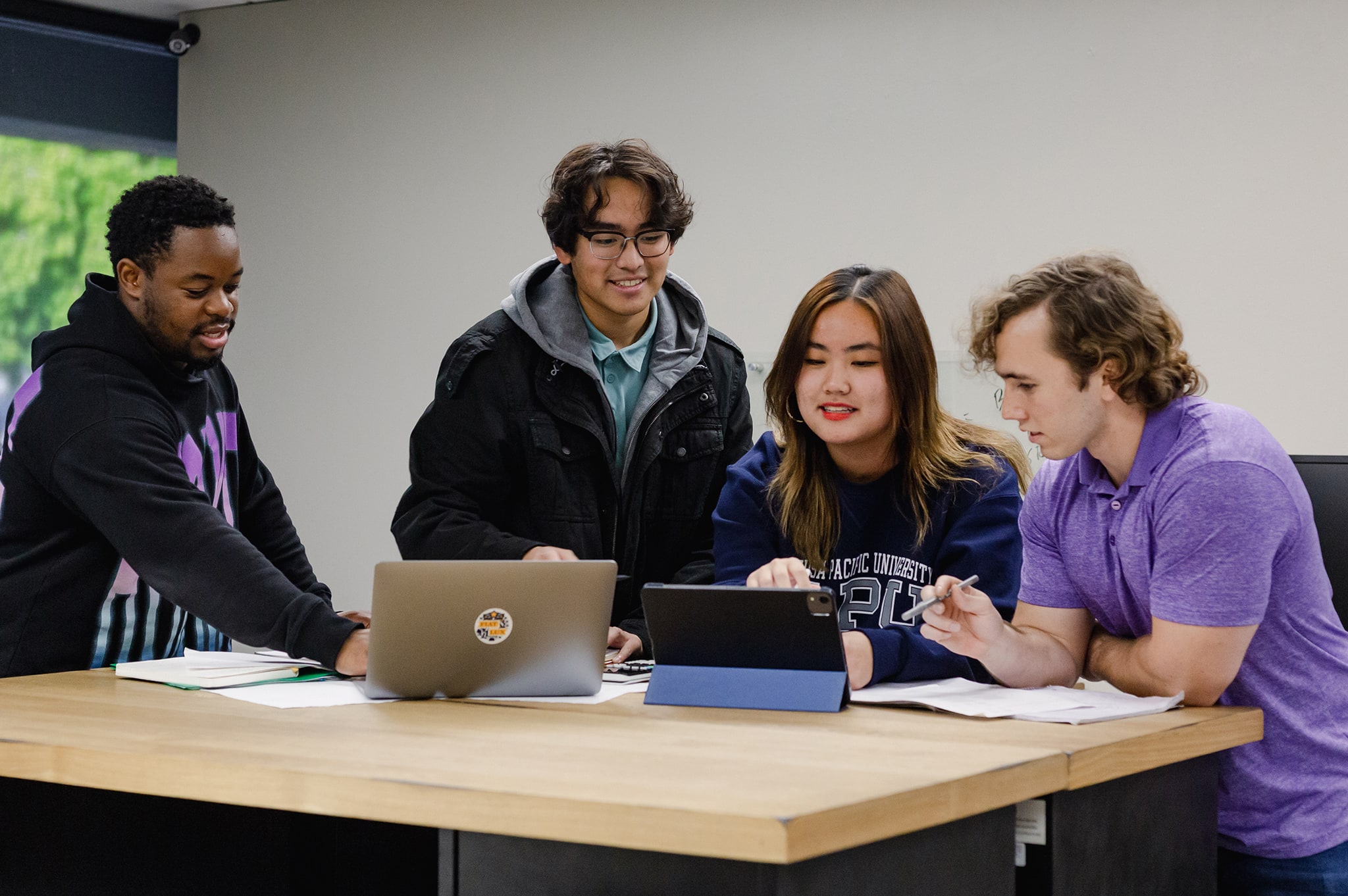 students gathered using their laptops