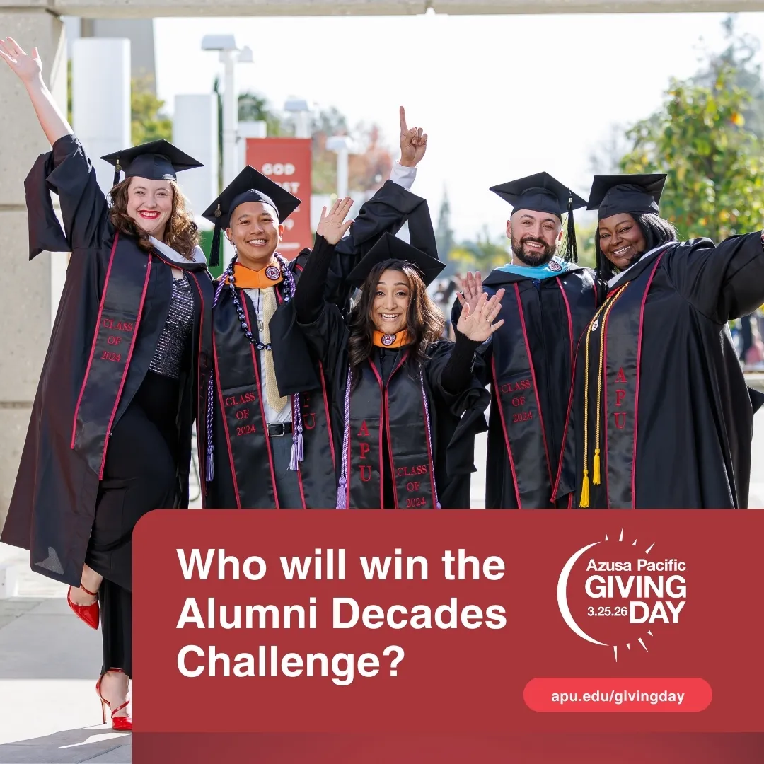 APU Graduates smiling with hands in the air