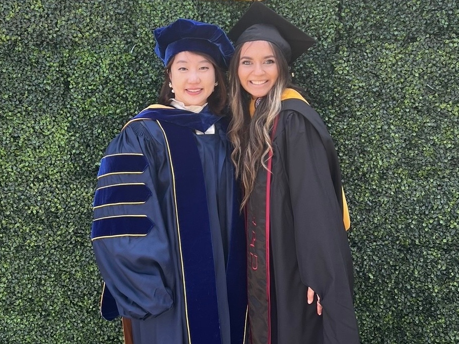 Rebecca Burtea and Soeun Kim stand together at graduation