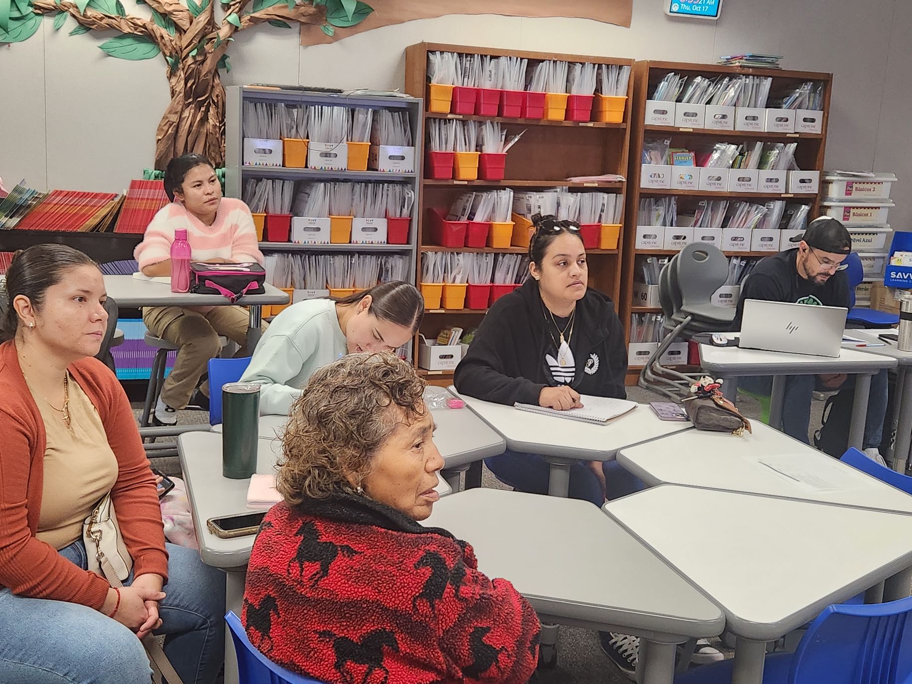 Adults in the Grassroots ESL Program attend a tutoring session in a classroom.