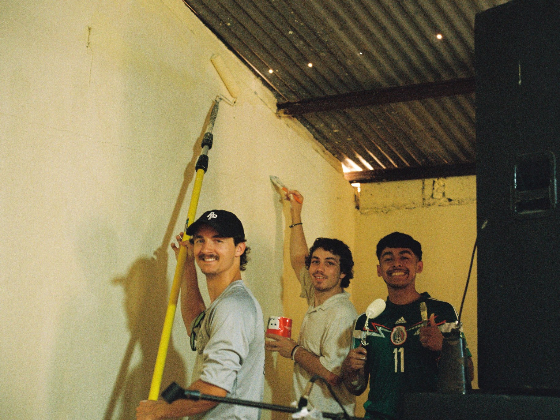 Students painting house wall