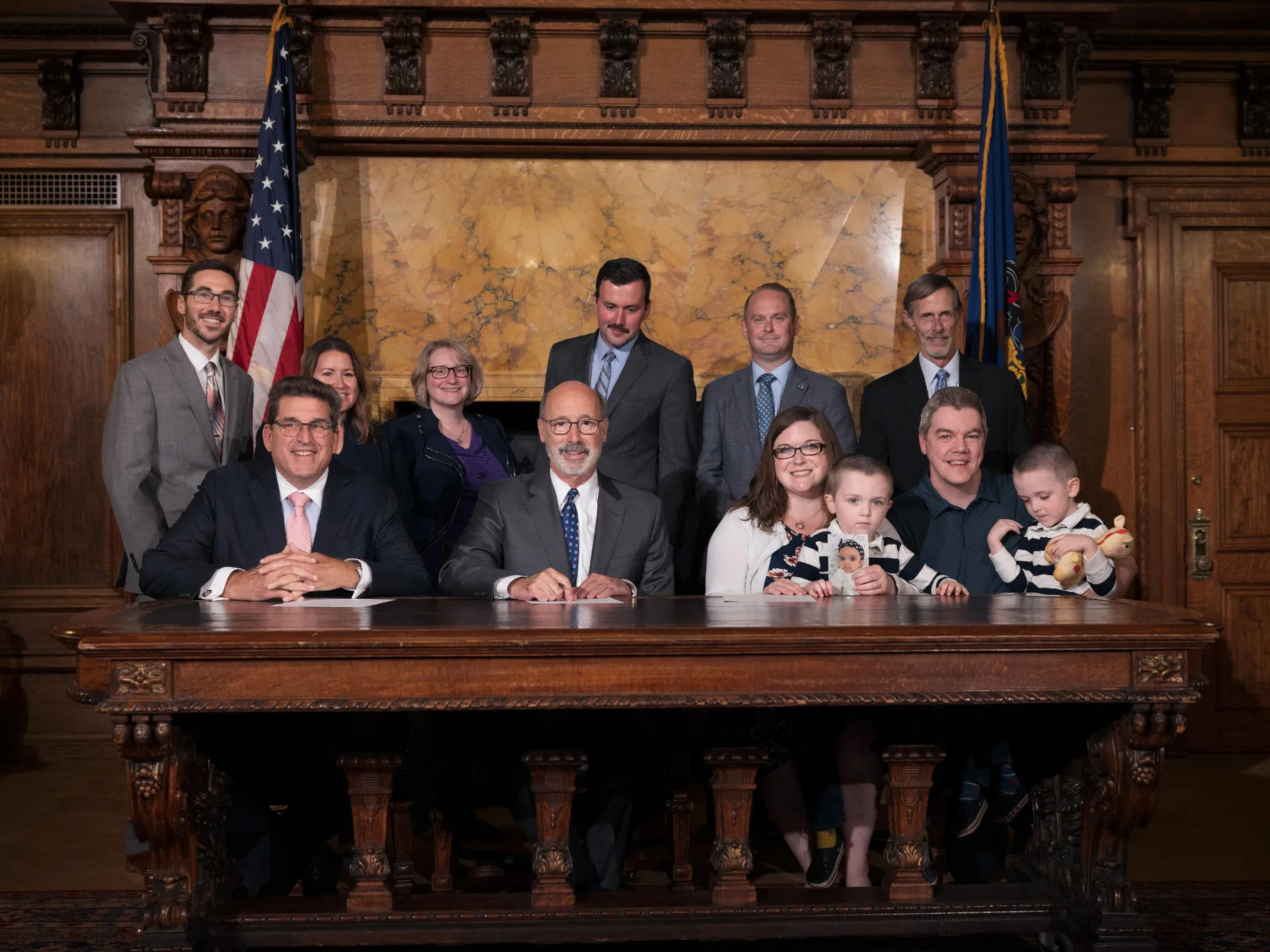Lesa Brackbill and her family join Pennsylvania officials for the signing of legislation at the state capitol.