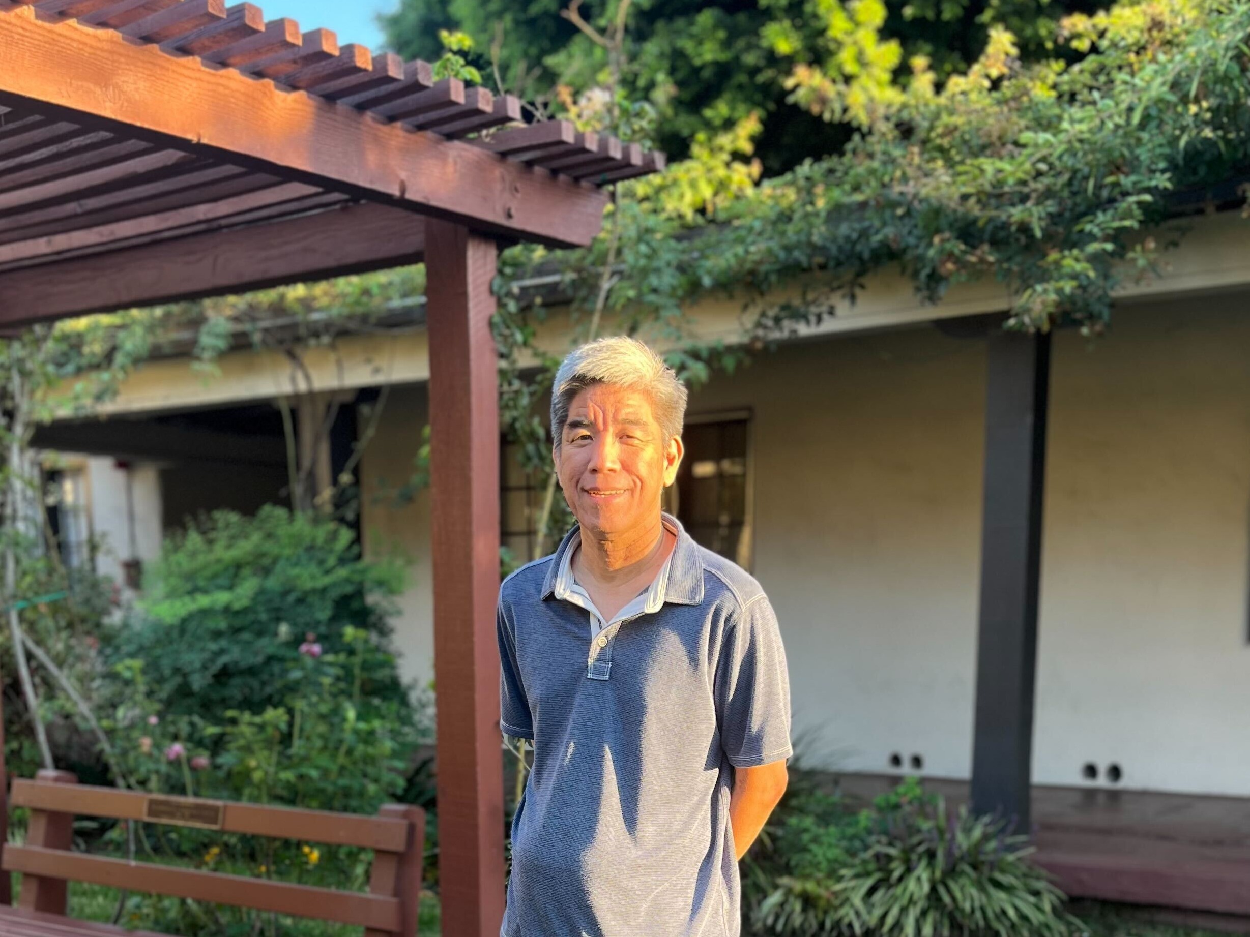 David Miyahara smiles in APU's beloved Rose Garden.