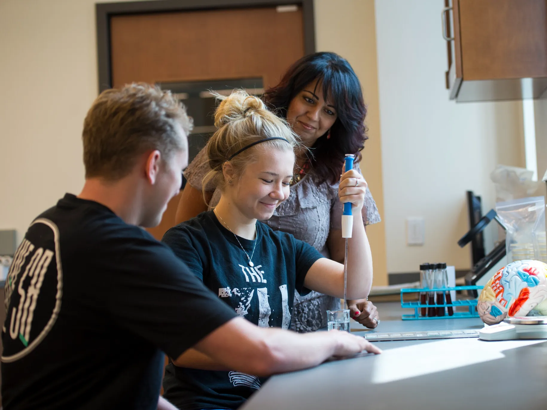 student doing activity in class with professor