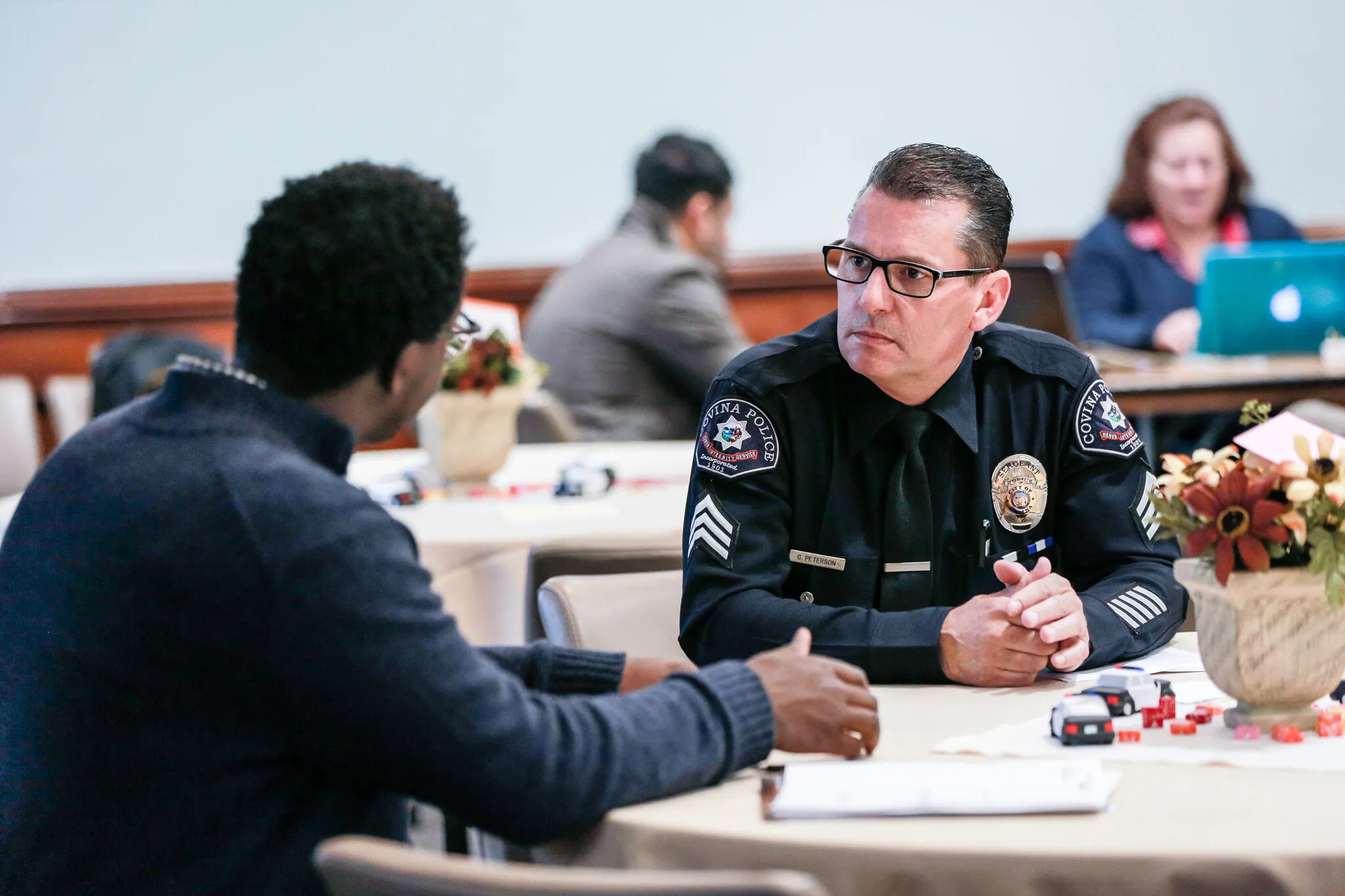 student talking to a police man during class
