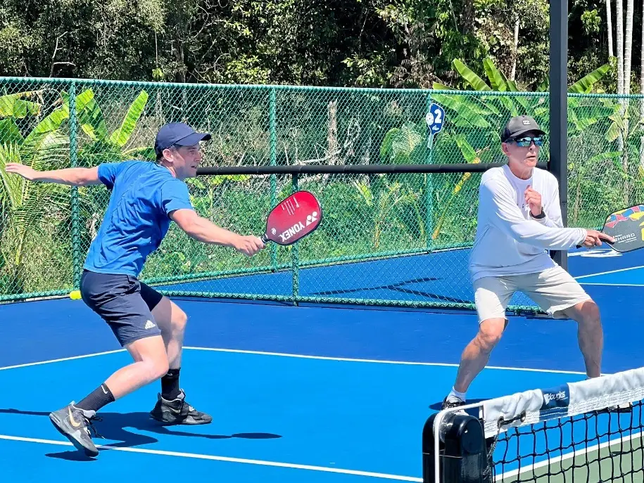 Daniel Moore plays pickleball with his father.