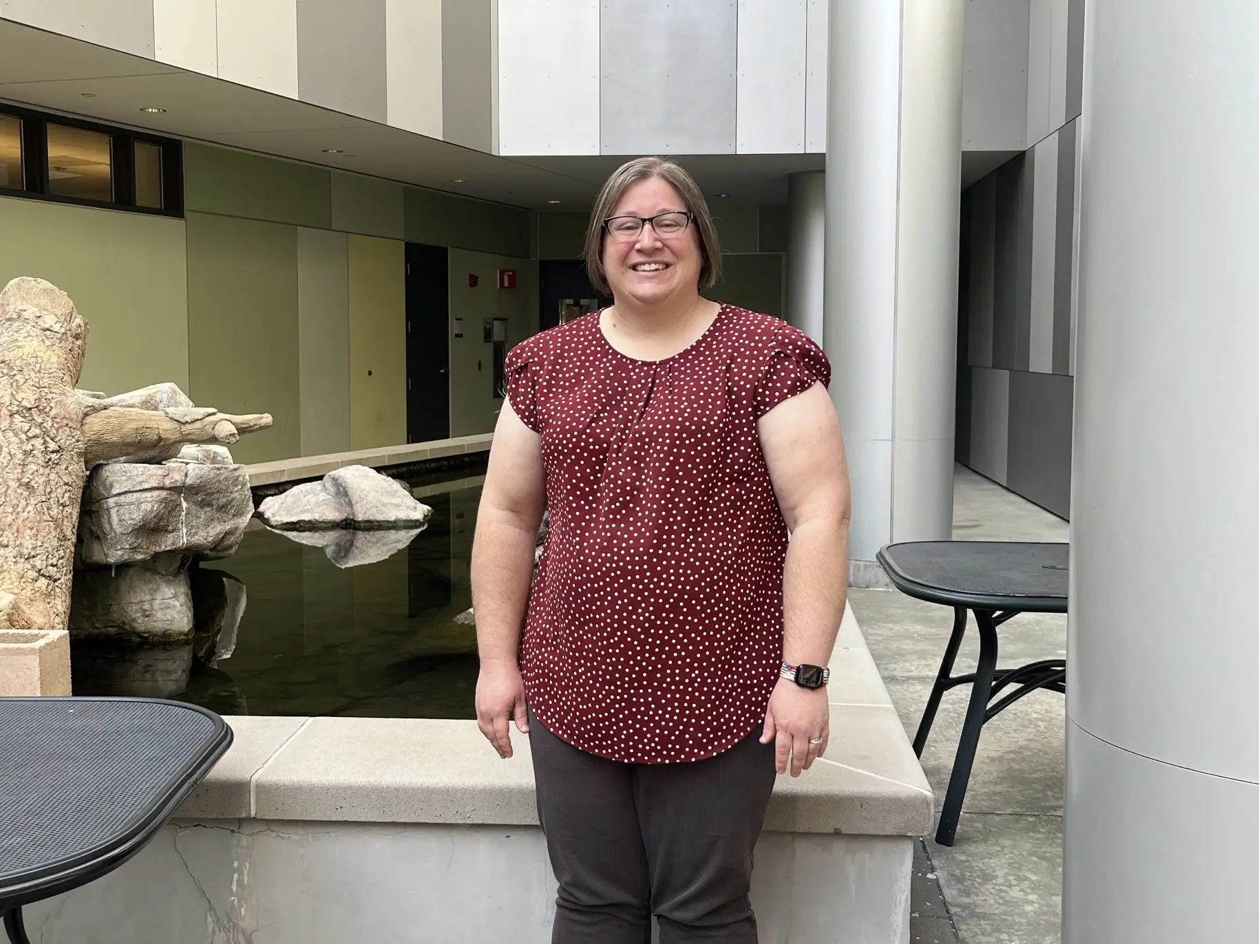 Jennifer Young smiles for a picture in front of the Segerstrom turtle pond.