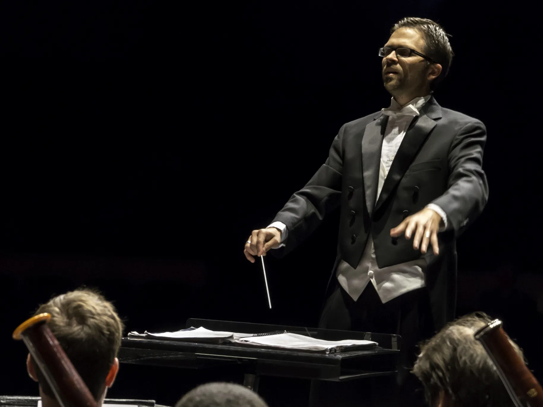 John Burdett conducting a music performance.