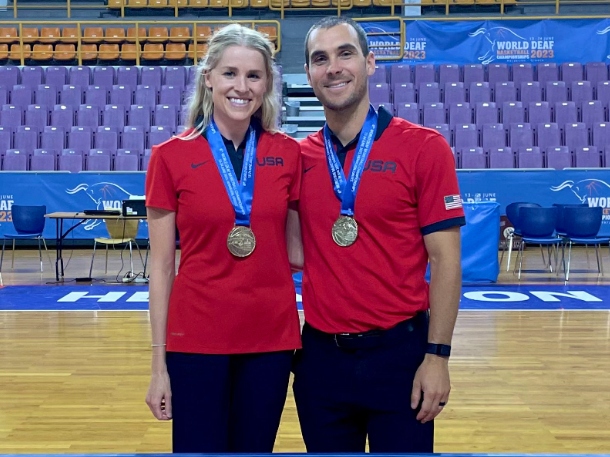 Natalie and Chris smiling with their medals