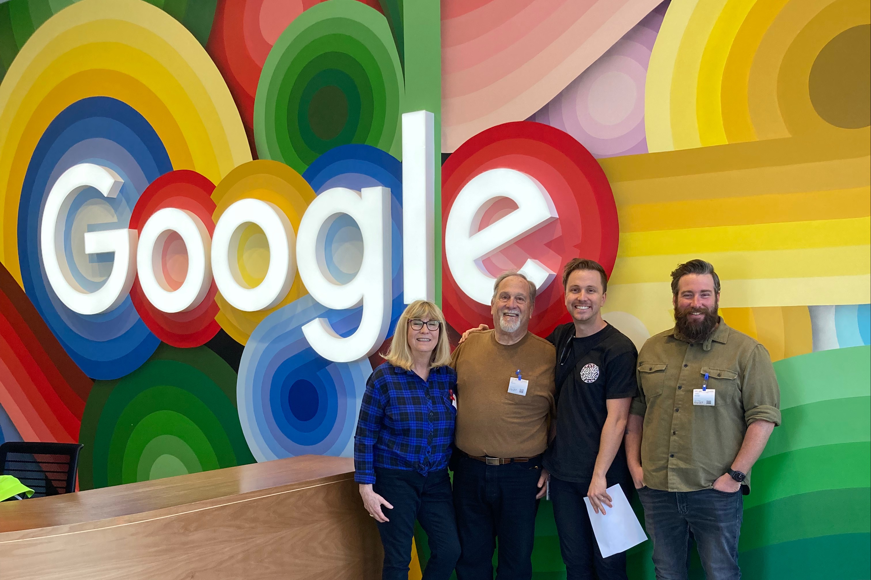 nicky with his coworkers outside a giant google sign