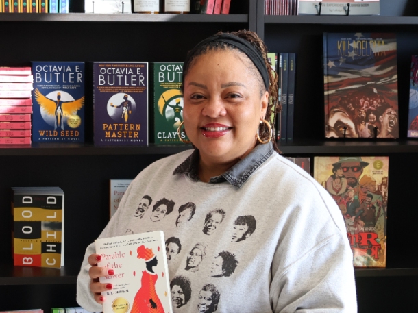 Nikki High smiling and holding a book