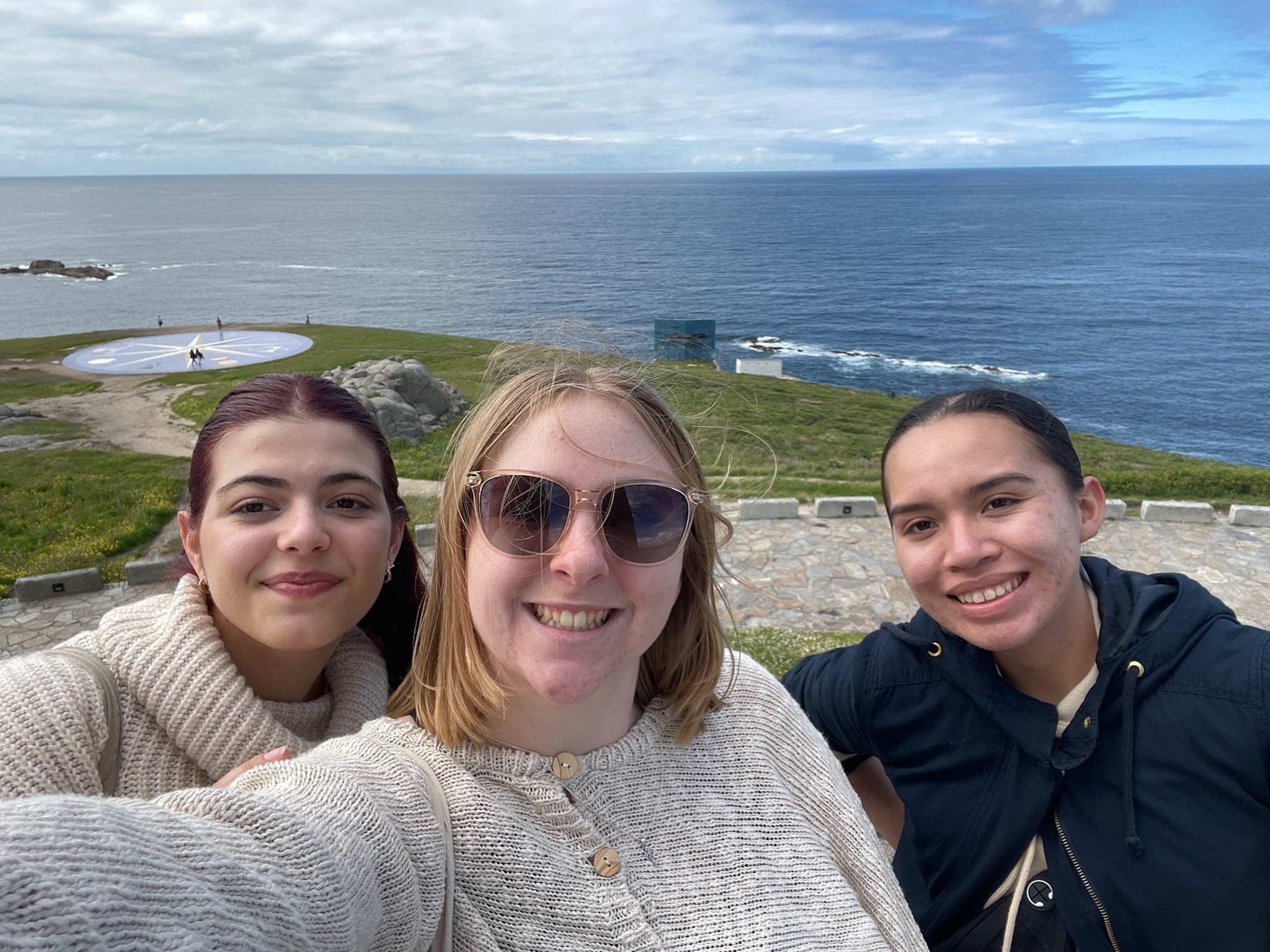 Group selfie in front of ocean in Spain