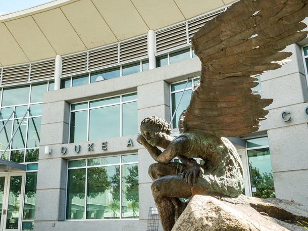 statue of man with wings that is located in front of duke complex at apu