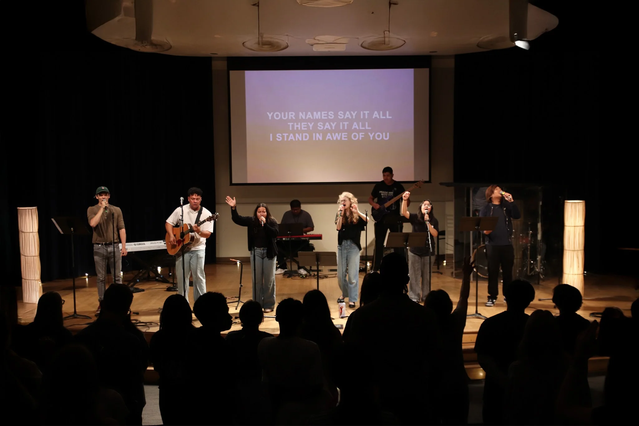 students worshiping together on stage