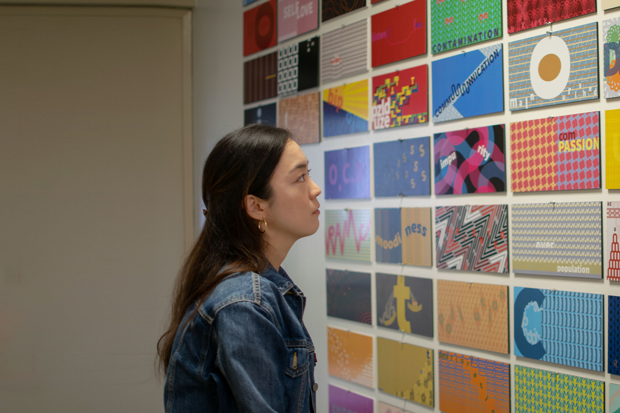 student looking at design elements on the wall