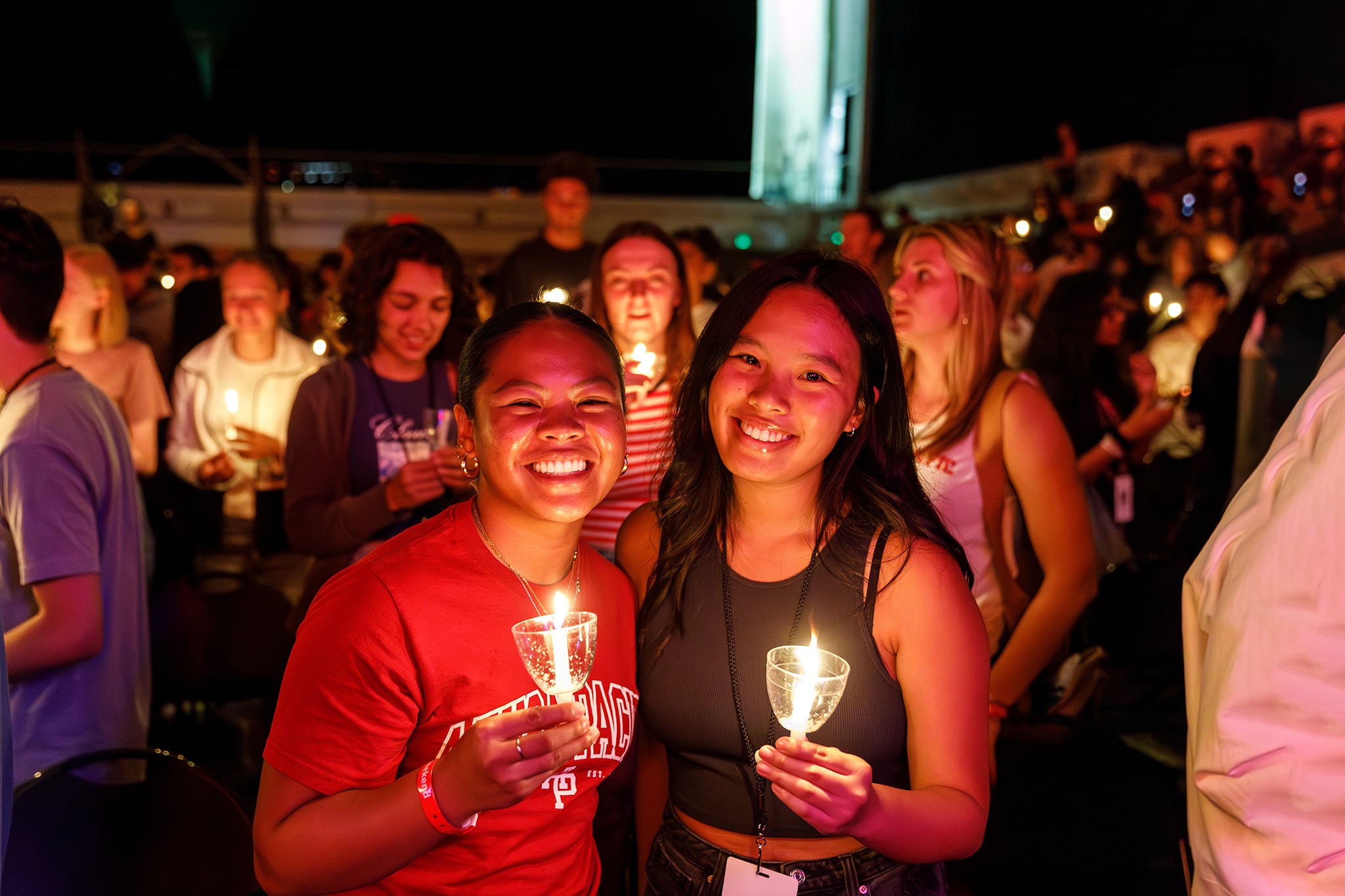 studwents holding a candle and smiling during welcome weekend event