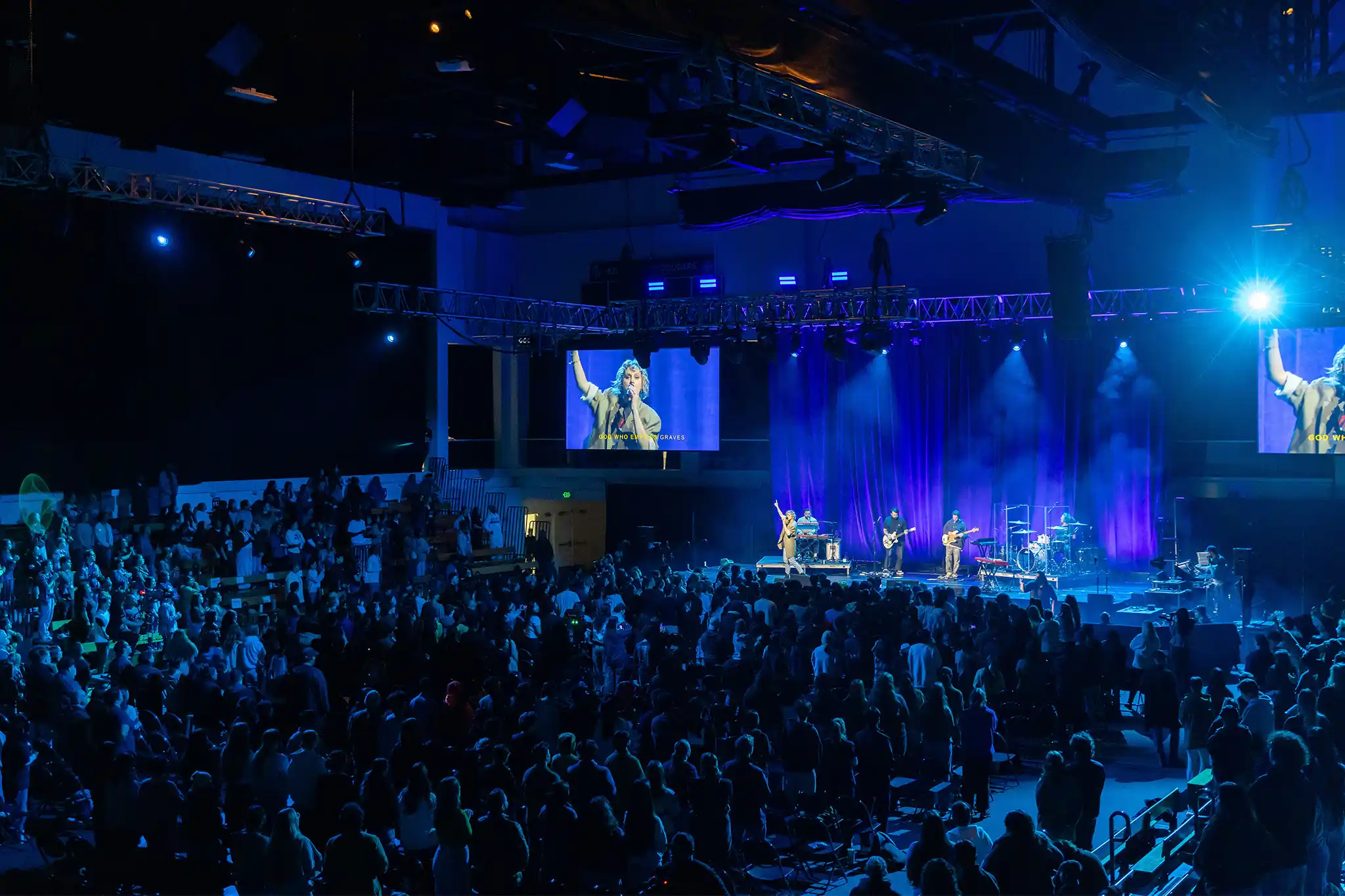 Student in I heart APU shirt smiling