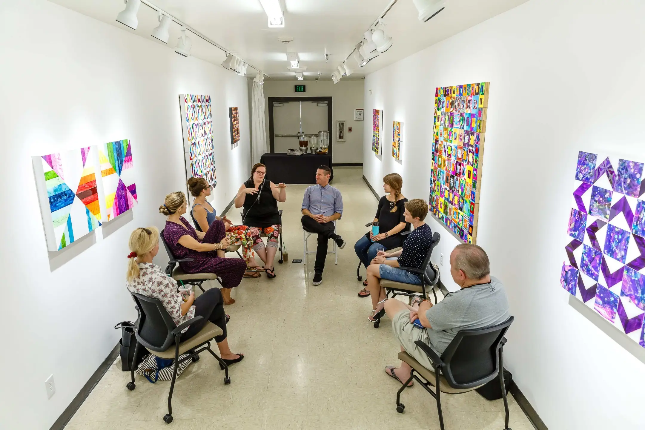 Group of students sitting in a circle between arts