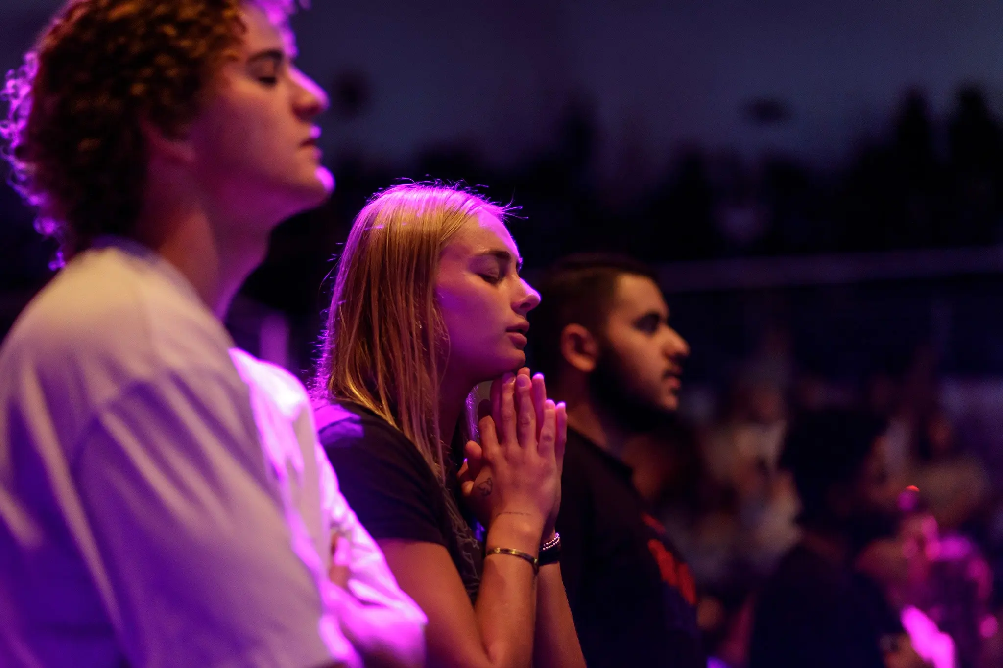 Student worshipping in chapel