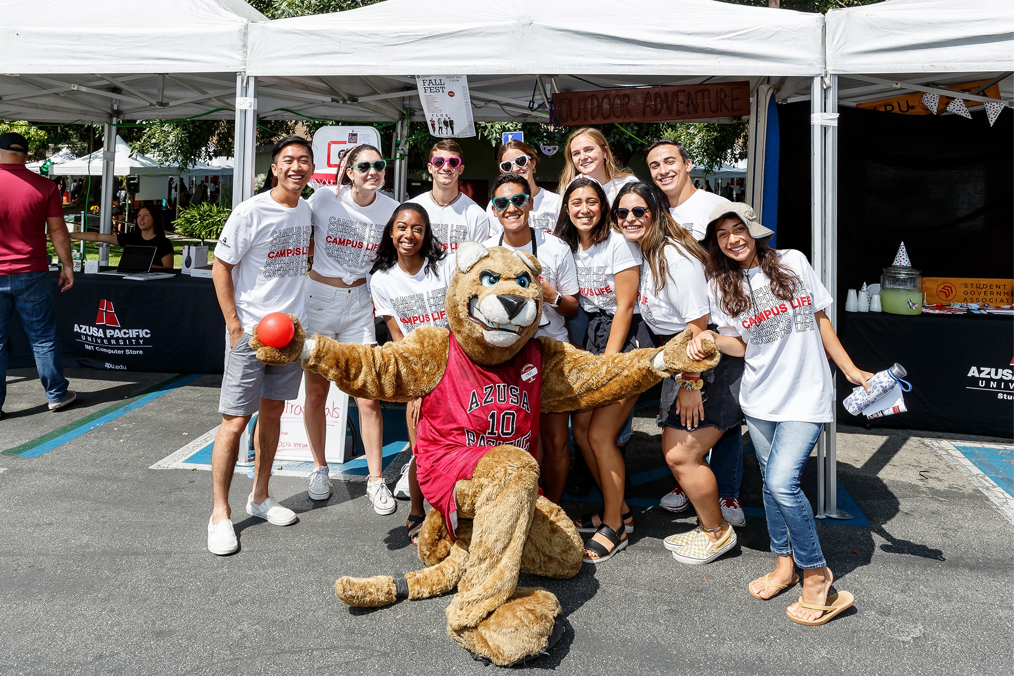 Students smiling with mascot