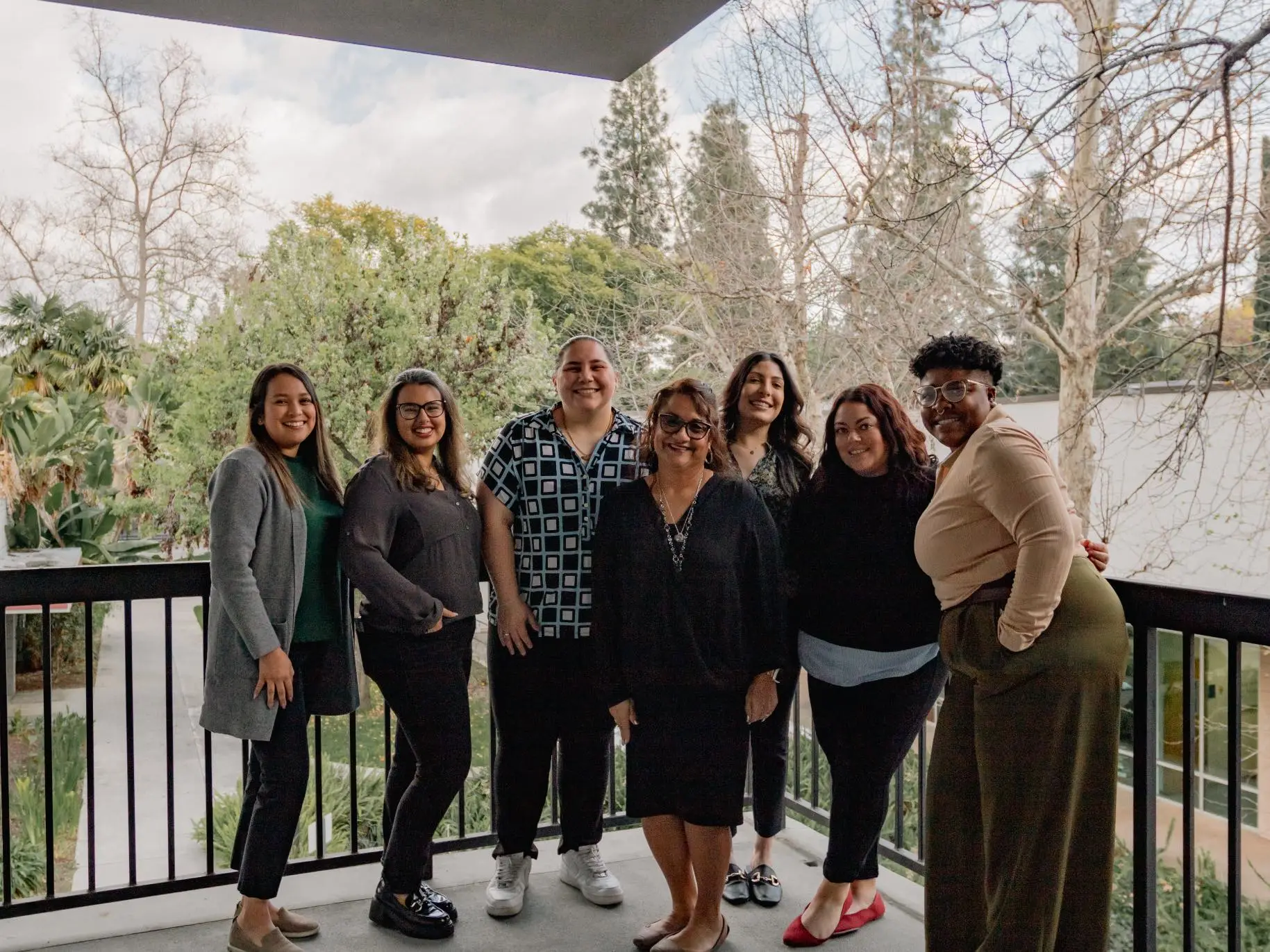 The 2024 DCFS graduating cohort stands outside with Virginia Olivas.